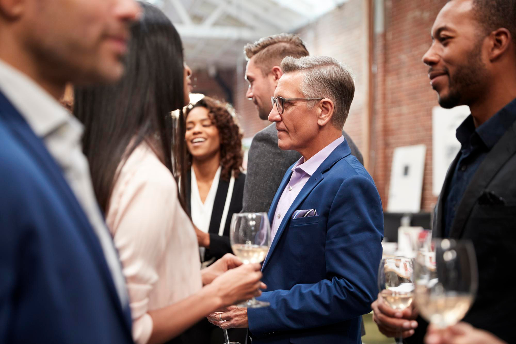 business-team-socializing-after-works-drinks-modern-office