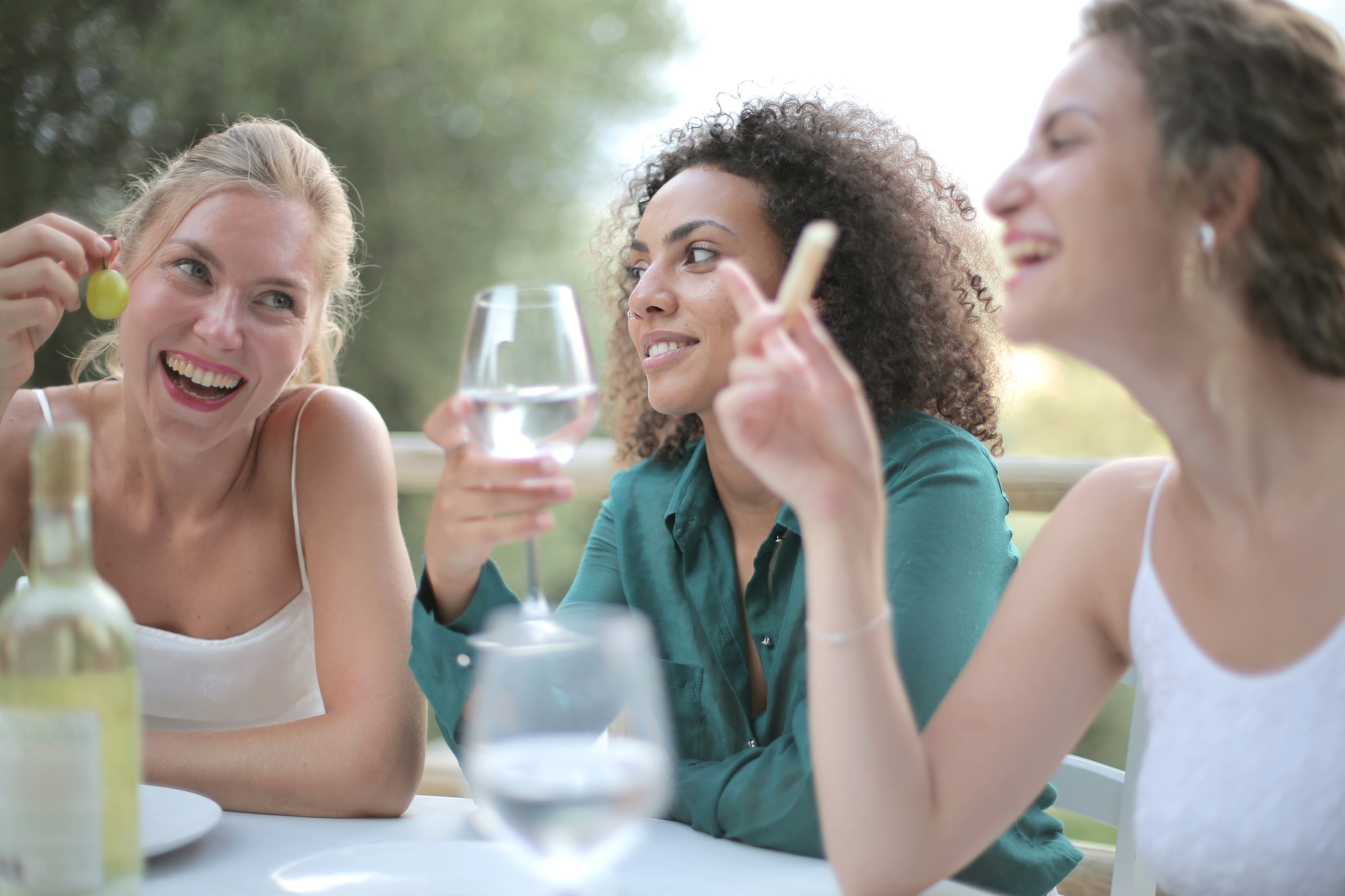 female-friends-each-other-drinking-wine-laughing