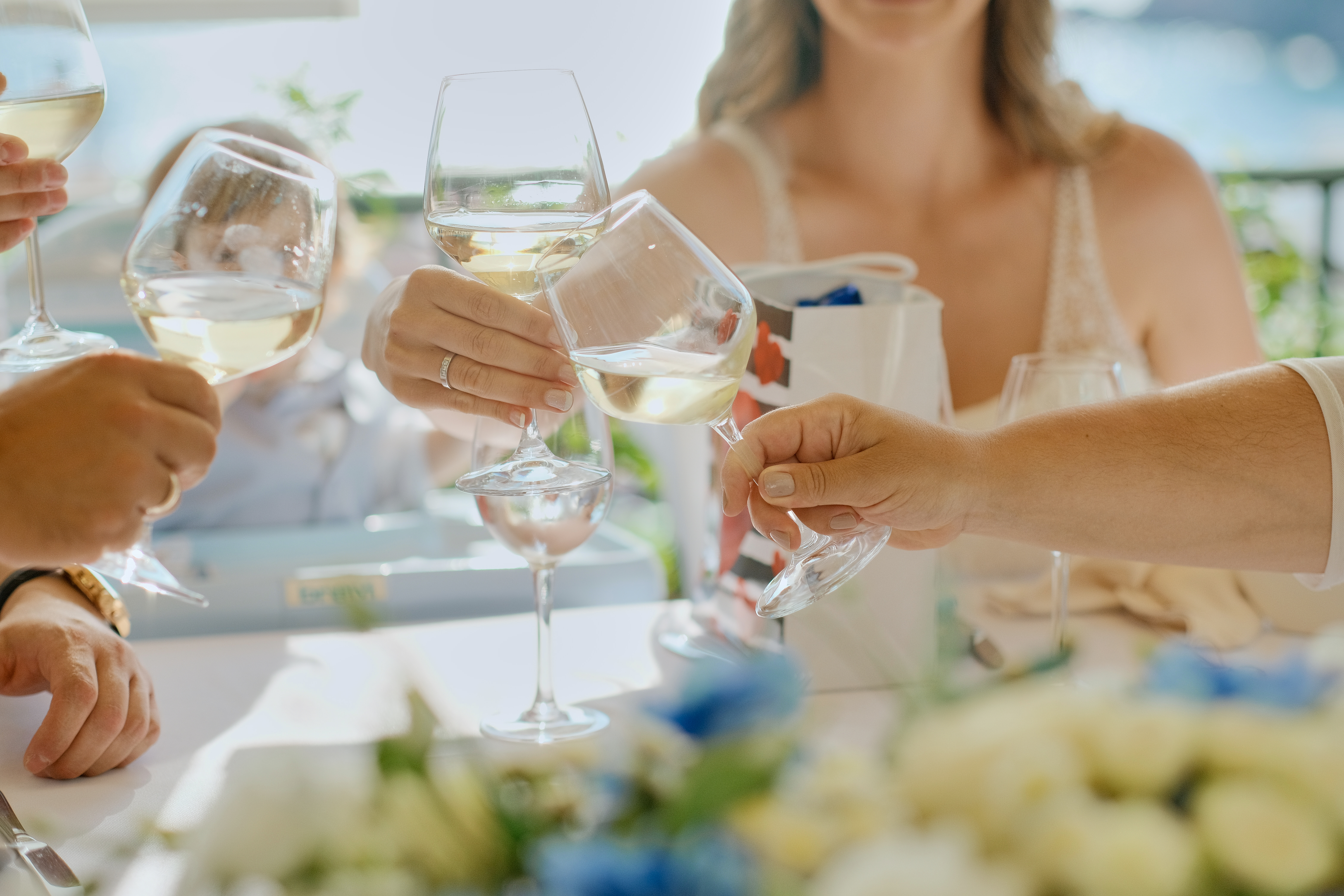 people-hands-with-glasses-wine-champagne-table-terrace-friends-meeting